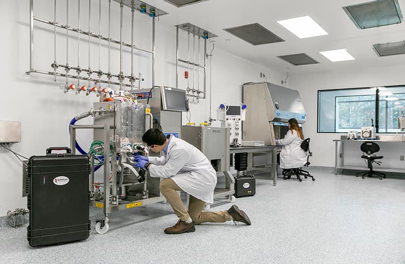 Surplus Solutions engineers servicing pharma and biotech equipment in a cleanroom